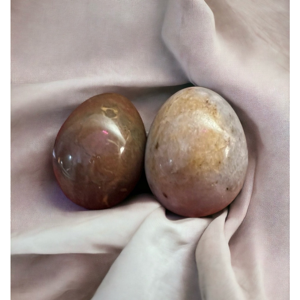 A pair of antique alabaster eggs in reddish brown and grey with speckles